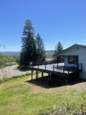 Top of Troost deck with a view of Roseburg - Like any large second story edition this deck was a challenge, but it was a lot of fun. 6 x 6 posts and 6 x 6 top plates being tied in by 4 x 10 ledgers and joists. It was massive and heavy. We have a lot of fun building this. We love to build and to show our Montana style. A beautiful back in a beautiful location.