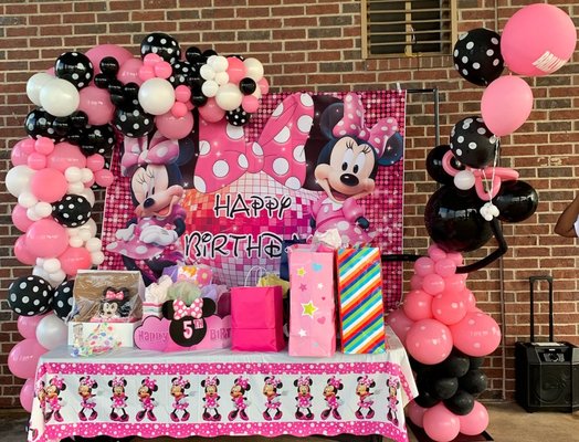 Minnie Mouse Party - This party was one of the first balloon decors I started. It was for my cousin's daughter who was turning 5 years old. I provided the stand for the balloons and she provided the background. This balloon decor is approximately a total 10ft length garland with the stand being 7ftx5ft. My stand can extend to 10ftx10ft if needed. The Minnie Mouse structure is out off all balloons, she is attached to the stand, however she could stand alone on her own. She is holding a few helium balloons which is also a service that is offered along with a customized 17in balloon with her name on it. Minnie Mouse Party - This party was one of the first balloon decors I started. It was for my cousin's daughter who was turning 5 years old. I provided the stand for the balloons and she provided the background. This balloon decor is approximately a total 10ft length garland with the stand being 7ftx5ft. My stand can extend to 10ftx10ft if needed. The Minnie Mouse structure is out off all balloons, she is attached to the stand, however she could stand alone on her own. She is holding a few helium balloons which is also a service that is offered along with a customized 17in balloon with her name on it.