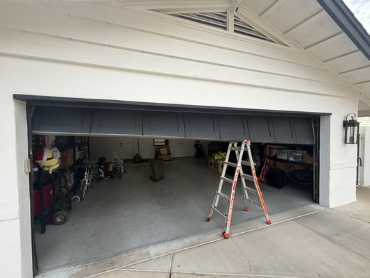 Off Track Garage Door - This garage door came completely off track and was left hanging sideways, with bent hinges and damaged track. Instead of replacing the entire door, we were able to get everything back into place, repair the damaged components, properly balance the door, and get it running smoothly and safely again. Off Track Garage Door - This garage door came completely off track and was left hanging sideways, with bent hinges and damaged track. Instead of replacing the entire door, we were able to get everything back into place, repair the damaged components, properly balance the door, and get it running smoothly and safely again.