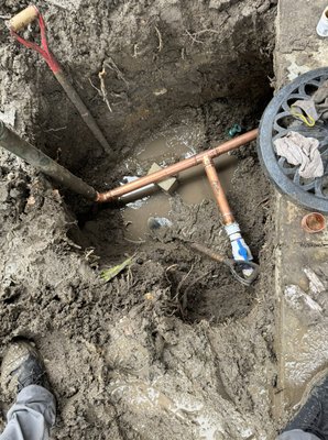 "Outdoor Water main Line and Irrigation Repair" - This project involved repairing an outdoor water line in challenging, muddy conditions. We excavated the area, removed damaged sections of piping, and installed new copper connections to restore water flow. The setup includes a backflow prevention device and ensures proper irrigation and water management for the landscape. Despite the weather, the repairs were completed efficiently to secure the water system. "Outdoor Water main Line and Irrigation Repair" - This project involved repairing an outdoor water line in challenging, muddy conditions. We excavated the area, removed damaged sections of piping, and installed new copper connections to restore water flow. The setup includes a backflow prevention device and ensures proper irrigation and water management for the landscape. Despite the weather, the repairs were completed efficiently to secure the water system.