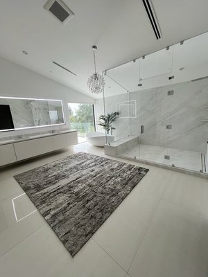 Bathroom Renovation 2024 - “This bathroom was designed and built in a newly constructed home to match the modern elegance of the rest of the space. We installed a frameless glass shower with eye-catching geometric tiles, added a freestanding tub for a spa-like feel, and used wood-look tile flooring for warmth and durability. The result is a luxurious, functional retreat that perfectly complements the home’s contemporary design!”