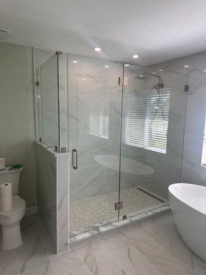 Modern Swing Door Shower Enclosure in Sarasota. - We recently completed an installation of a stunning swing door shower enclosure in Sarasota. Featuring polished chrome hardware and 3/8" super clear tempered glass, this project highlights the elegance and functionality of modern design. Our client now enjoys a sleek, spacious shower with a crystal-clear view, enhancing their bathroom's aesthetic and value.