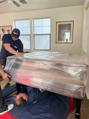 Baby Grand Piano Relocation - We were called to relocate a baby grand piano from Chandler, AZ to Mesa, AZ. The lyre and legs are disassembled from baby grand for relocation, which are padded and wrapped. Then placed on piano board, and ready for transit!