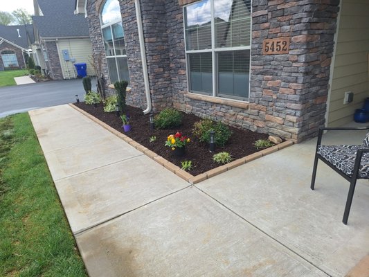 Interlocking edger brick border with brown mulch - On this project, we removed all the old mulch and disposed of it. we installed an interlocking edger brick border, and we installed new landscaping fabric and brown mulch