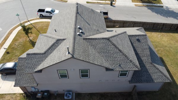 Roof Replacement - San Marcos, TX - We completed this roof replacement in October 2024 for a homeowner in San Marcos, TX after a strong windstorm hit the area in May. The original 3-tab roof had major wind damage, with multiple shingles blown off or lifted.
Right after the storm, we came out and installed a tarp to prevent any leaks or further damage. Thanks to the temporary protection, the homeowner didn’t experience any interior water issues while we worked through the insurance process.
We were able to assist her every step of the way with her insurance claim, and in the end, upgraded her to architectural shingles—at no additional cost. The new roof not only looks better but provides improved durability and wind resistance. Roof Replacement - San Marcos, TX - We completed this roof replacement in October 2024 for a homeowner in San Marcos, TX after a strong windstorm hit the area in May. The original 3-tab roof had major wind damage, with multiple shingles blown off or lifted.
Right after the storm, we came out and installed a tarp to prevent any leaks or further damage. Thanks to the temporary protection, the homeowner didn’t experience any interior water issues while we worked through the insurance process.
We were able to assist her every step of the way with her insurance claim, and in the end, upgraded her to architectural shingles—at no additional cost. The new roof not only looks better but provides improved durability and wind resistance.