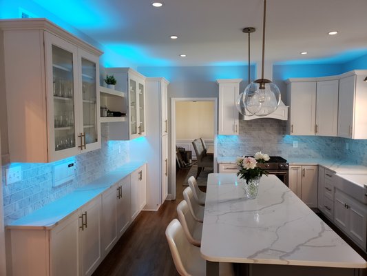 1980's Kitchen Remodeling - We completely changed this outdated 1980's kitchen into the best kitchen we have done up to date. The ceilings were low, there was not enough light and the cabinets were really dark. Even so they might have been a great choice 40 years ago. Once we ripped everything out we found out that we have the opportunity to raise the ceilings by about a foot. The previous owners lowered them just so they can accommodate for the 30" wall cabinets which made the space feel quite small and confined. There was not enough light in the kitchen and we fixed that as well. We added 8 recess lights and 4 pendants. Later on I suggested to add the under cabinet and above cabinet lights which really makes the kitchen pop. This is by far my favorite kitchen up to date. The cabinets are Marsh custom cabinets. The countertops are quartz and the backsplash is Carrara marble tile. We added range hood and converted the stove to gas. We also installed a range oven in one of the cabinets in the island which is not visible on the pictures. The sink is kohler cast iron sink which weights a lot and needed extra support. The LED under cabinet / above cabinet lights are a game changer. Changing colors, different set ups and remote. Option to turn them off separately or at the same time. By far ... our best kitchen up to date.