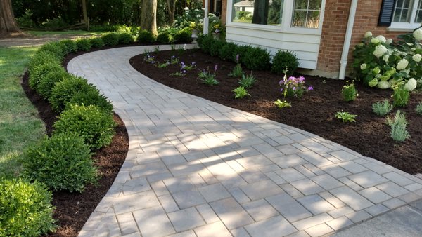 Walkway entrance - A lush lawn and bountiful garden beds are cornerstones of streetside aesthetics but look a little closer at the best house on the block and you’ll likely see another secret weapon when it comes to curb appeal. Whether as a walkway, driveway, or retaining wall, pavers can transform your front yard. Walkway entrance - A lush lawn and bountiful garden beds are cornerstones of streetside aesthetics but look a little closer at the best house on the block and you’ll likely see another secret weapon when it comes to curb appeal. Whether as a walkway, driveway, or retaining wall, pavers can transform your front yard.