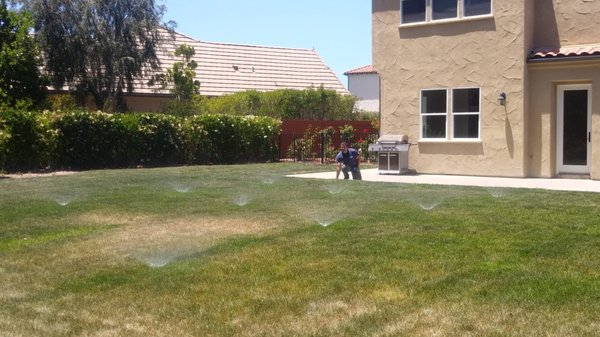 Sprinkler Systems - Whether you’re wanting to put your home up for sale or just improve the overall look, a well-landscaped yard will make a huge impact. According to experts, a well-landscaped yard can increase the value of your home anywhere from 5%-13%. Imagine adding over $30,000 in value just through a little outside beautification! As professional landscapers, we are equipped to help select the right landscaping to upgrade your yard.

In recent years, especially in California, water conservation has been a hot topic. While a well-landscaped home or rolling green grassy hills might be desired, the water bill and environmental impact that comes from all that watering it is not quite as appealing. Drought tolerant plants are a great option and are growing in popularity because of their limited watering requirements. Still, finding yourselves craving a golf worthy yard but hoping not to break the bank? Thankfully, there’s a solution!

Sprinkler systems are an excellent way to provide proper irrigation to your yard or business. Having a sprinkler system takes care of many concerns at once. First and foremost, modern systems are actually equipped with water gauges and moisture censors which help to deliver the correct amount of water to your plants. They can even be programmed to water plants at the optimum scheduled time of your liking. Secondly, this high-tech way of watering your yard actually cuts down on costs, saving the average user hundreds of dollars a year.

We have the skills and knowledge to install the perfect sprinkler system for your needs. Call today to schedule a consultation.