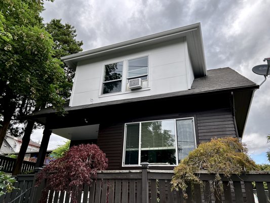 Exterior painting for Chris K in Seattle - After years of weathering Seattle’s rain and wind, our home’s wood siding was in rough shape-peeling paint, visible cracks, and a tired, faded look. Determined to restore its charm but with modern colors. A house well-prepped is a job half-done.
Day 1: Inspection and Washing
We started by thoroughly inspecting every inch of the siding, looking for rot, soft spots, and moisture damage-common issues in Seattle’s damp climate. Satisfied that the wood was sound enough to repaint, we power washed the entire exterior, using just enough pressure to remove dirt, mildew, and loose paint without damaging the wood. Then, we let the siding dry completely overnight, knowing moisture trapped under paint would spell disaster later.
Day 2: Scraping and Sanding
Once dry, we tackled the peeling paint. Using scrapers and sanding blocks, we removed every flake of loose paint, smoothing rough edges and sanding down weathered patches to expose fresh wood. We paid special attention to areas where the wood had grayed, since weathered wood won’t hold new paint.
Day 3: Repairs and Caulking
Next, we filled holes and dents with exterior-grade wood filler and replaced any cracked or damaged boards. After the filler dried, we sanded the patches smooth. Then, we carefully caulked all cracks and gaps-except between overlapping siding boards, which need to breathe to prevent trapped moisture. We used a high-quality, paintable exterior caulk, making sure every seam was sealed against Seattle’s rain.
Day 4: Priming.
With repairs complete, we applied a coat of primer to all bare wood and patched areas, ensuring even coverage and a solid base for the new paint. We let the primer dry thoroughly, checking for any spots that needed a second coat.
Days 5–7: Painting
It was finally time for color. We started at the top of the house, brushing and rolling chocolate brown onto the siding, always working in the direction of the wood grain for the best finish. For the trim, we switched to bright white, using smaller brushes for crisp edges around windows and doors. We overlapped each stroke for even coverage and took care not to paint in direct sun or when rain threatened-a real concern in Seattle. Between coats, we allowed ample drying time, knowing that patience here meant a longer-lasting result.
Day 8: Touch-Ups and Cleanup
On the last day, we walked the house, touching up missed spots and cleaning up drips. We removed masking tape, reinstalled fixtures, and admired the transformation. The rich chocolate siding and sharp white soffits, panels and gutters gave the house a fresh, modern look-and a new lease on life.
From inspection to the final brushstroke, every step was crucial. By taking our time and following best practices, we gave our Seattle home a durable, beautiful finish that will stand up to the Northwest weather for years to come. Exterior painting for Chris K in Seattle - After years of weathering Seattle’s rain and wind, our home’s wood siding was in rough shape-peeling paint, visible cracks, and a tired, faded look. Determined to restore its charm but with modern colors. A house well-prepped is a job half-done.
Day 1: Inspection and Washing
We started by thoroughly inspecting every inch of the siding, looking for rot, soft spots, and moisture damage-common issues in Seattle’s damp climate. Satisfied that the wood was sound enough to repaint, we power washed the entire exterior, using just enough pressure to remove dirt, mildew, and loose paint without damaging the wood. Then, we let the siding dry completely overnight, knowing moisture trapped under paint would spell disaster later.
Day 2: Scraping and Sanding
Once dry, we tackled the peeling paint. Using scrapers and sanding blocks, we removed every flake of loose paint, smoothing rough edges and sanding down weathered patches to expose fresh wood. We paid special attention to areas where the wood had grayed, since weathered wood won’t hold new paint.
Day 3: Repairs and Caulking
Next, we filled holes and dents with exterior-grade wood filler and replaced any cracked or damaged boards. After the filler dried, we sanded the patches smooth. Then, we carefully caulked all cracks and gaps-except between overlapping siding boards, which need to breathe to prevent trapped moisture. We used a high-quality, paintable exterior caulk, making sure every seam was sealed against Seattle’s rain.
Day 4: Priming.
With repairs complete, we applied a coat of primer to all bare wood and patched areas, ensuring even coverage and a solid base for the new paint. We let the primer dry thoroughly, checking for any spots that needed a second coat.
Days 5–7: Painting
It was finally time for color. We started at the top of the house, brushing and rolling chocolate brown onto the siding, always working in the direction of the wood grain for the best finish. For the trim, we switched to bright white, using smaller brushes for crisp edges around windows and doors. We overlapped each stroke for even coverage and took care not to paint in direct sun or when rain threatened-a real concern in Seattle. Between coats, we allowed ample drying time, knowing that patience here meant a longer-lasting result.
Day 8: Touch-Ups and Cleanup
On the last day, we walked the house, touching up missed spots and cleaning up drips. We removed masking tape, reinstalled fixtures, and admired the transformation. The rich chocolate siding and sharp white soffits, panels and gutters gave the house a fresh, modern look-and a new lease on life.
From inspection to the final brushstroke, every step was crucial. By taking our time and following best practices, we gave our Seattle home a durable, beautiful finish that will stand up to the Northwest weather for years to come.