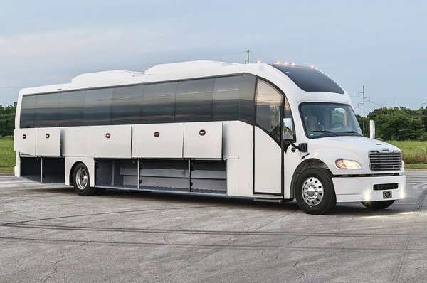 Coach Bus - Our premium Luxury Coach Bus is the ultimate solution for high-end group travel. Equipped with plush, reclining leather seats, individual climate control, and extra legroom, this coach ensures maximum comfort for every passenger. The bus features a modern entertainment system, including flat-screen monitors, & premium sound, making long trips both enjoyable and productive.