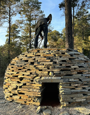 History About us. - The Legacy of Peter Joseph Mullins (1947–2022)
The Mendocino Ranch, aka The Mendocino Stone Zone, was started in 2002 by our late founder, Peter Joseph Mullins.
When Peter Mullins first bought his retirement home in Gualala, California, it was a simple one bedroom cabin on 5 acres in the woods. But as a big man with big dreams, that simply would not do! Today the Stone Ranch expands to 50 acres and sleeps 25+ in 3 different areas around the estate. The property showcases his life long collections of tile, brick and stone and displays the results of his daily work; clearing brush and trimming trees. He did this to create a more fire safe environment ..with the added benefit of making room for more stones!  The Stone Ranch of today is a magical retreat in a manicured forest of native plants and trees, where pebble lined paths lead through a lifted canopy of trees to feats of masterful masonry. Rocks shoot up from the earth around every corner. It is a delight of discovery for people of all ages. This was Peters greatest hope; to share the joy , excitement and enchantment he felt walking through his “stone zone”.
On the Mendocino Stone Ranch property you will find Peter’s hand picked collections. There are fossilized mudstone, that date back millions of years, which he gathered from a beach front  family property in Aptos, CA. You will also find the rounded red remnants from a defunct tile and brick factory on Catalina Island. Peter was captivated when he first saw the ocean tumbled brick and tile rolling in the tide line,  splashing the beach with color. He brought 5 gallon buckets every time he visited after that, and ferried home with his buckets full. He was mesmerized by what he gathered and kept them with him, moving from city home to city home, LA to San Francisco; and finally to their present spot at the Mendocino Stone Ranch where they could be spread throughout the land.
Peter traveled the country to pursue other collections as well. As you walk through the Stone Ranch, you are walking through decades of Peter’s explorations. He enjoyed finding stone in quarries, and tiles from the makers. He liked the hard-scape appeal of the crushed brick out of Southern California and the mica quartzite schist from the Mojave. Peter would meet artists and stone yards he wanted to support and continued to do so, filling his home and property. He relished in the business of connecting with people the product they supplied.
Thank you to the stone masons and thank you to the Stone Foundation and thank you Peter for your vision, obsession, and desire to share.