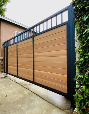 Metal and woods combined - An Entry Gate is a statement that sets the tone for your neighbors, visitors, friends and family. Gates are a great way to add charm, privacy and protection to your home.
All of our wood gates are mounted on a steel frame which doesn't twist or warp the way wood frames can do from time to time. Our wood is pre-treated with heavy duty sealant, to hold up against the elements for many years. Metal and woods combined - An Entry Gate is a statement that sets the tone for your neighbors, visitors, friends and family. Gates are a great way to add charm, privacy and protection to your home.
All of our wood gates are mounted on a steel frame which doesn't twist or warp the way wood frames can do from time to time. Our wood is pre-treated with heavy duty sealant, to hold up against the elements for many years.