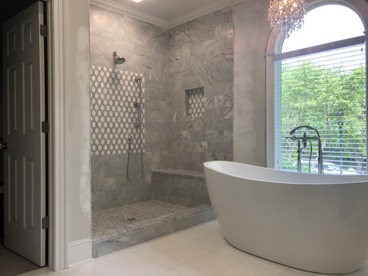 Cornelius Bath remodel before and after - We helped this Cornelius homeowner with their bath remodel. Our team removed and disposed the old tile on floor and in the shower. We also removed the sunk in tub. A contractor was brought in to repair the hole in the floor where the tub was removed and they did some drywall repairs. We installed a heated floor system by Schluter prior to installing the tile. We left the top of the curb and bench unfinished as the home owner wanted to have their granite company install a solid piece of marble in these areas. What a difference !! Cornelius Bath remodel before and after - We helped this Cornelius homeowner with their bath remodel. Our team removed and disposed the old tile on floor and in the shower. We also removed the sunk in tub. A contractor was brought in to repair the hole in the floor where the tub was removed and they did some drywall repairs. We installed a heated floor system by Schluter prior to installing the tile. We left the top of the curb and bench unfinished as the home owner wanted to have their granite company install a solid piece of marble in these areas. What a difference !!
