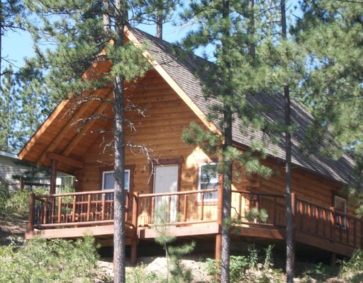 CABIN #6 Trail’s End - CABIN #6
Trail’s End

Non-Smoking

This cabin has 2 queen beds (one in the bedroom and one in the loft; which has custom log railing), an innerspring mattress futon in the loft, a queen sized hide-a-bed sofa in the living space and 2 full bathrooms.

It has a kitchenette with microwave, toaster, coffee pot, full size fridge and freezer, electric skillet, dishes, silverware and cooking utensils. The cabin has electric heat, AC and Satellite TV.

There is a large deck with covered front porch, picnic table and propane grill.  Great morning sun and afternoon Shade!