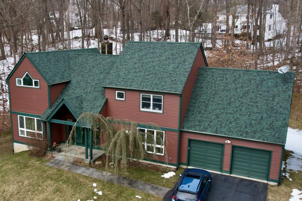 The Perfect Home for a Gikas Green Roof! - This home got a bold, custom upgrade with Owens Corning Duration shingles in Chateau Green — or as we like to call it, Gikas Green. The deep, earthy tone pairs perfectly with the home's red siding and green trim, creating a look that’s truly one-of-a-kind. Not only does it turn heads, but it also offers industry-leading durability and performance. This project is a perfect example of how a non-traditional shingle color can be used to make a statement while staying true to a home’s unique character. The Perfect Home for a Gikas Green Roof! - This home got a bold, custom upgrade with Owens Corning Duration shingles in Chateau Green — or as we like to call it, Gikas Green. The deep, earthy tone pairs perfectly with the home's red siding and green trim, creating a look that’s truly one-of-a-kind. Not only does it turn heads, but it also offers industry-leading durability and performance. This project is a perfect example of how a non-traditional shingle color can be used to make a statement while staying true to a home’s unique character.