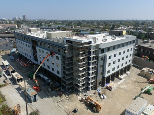 Hotel Development: San Mateo, CA. - These photos document the completion of the exterior wall color coat as well as window installation on floors 2-5. Further, this image documents the completion of metal sheeting along the roof and the Southwest corner of floors 1-5 and roof. Hotel Development: San Mateo, CA. - These photos document the completion of the exterior wall color coat as well as window installation on floors 2-5. Further, this image documents the completion of metal sheeting along the roof and the Southwest corner of floors 1-5 and roof.