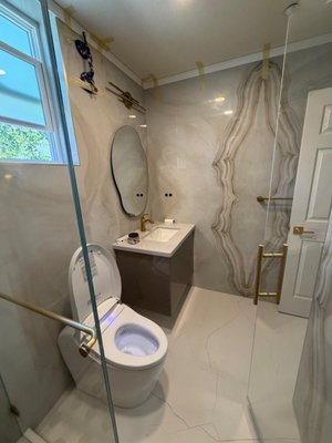 Bathroom Remodel - Los Altos - This bathroom went through a complete floor-to-ceiling renovation. We started with a full demolition down to the studs, updated the plumbing and electrical, and rebuilt the space from the ground up. The old tub was replaced with a spacious walk in shower featuring a custom bench, recessed niche, frameless glass enclosure, and premium brushed gold fixtures.
Large format porcelain slabs create a seamless, high end look throughout the walls, while the porcelain tile flooring adds durability and style. We installed a floating vanity with a quartz countertop, an LED mirror, a smart toilet, recessed lighting, and completed the project with fresh paint and clean finishing details.
The result is a bright, modern bathroom that feels much larger, more functional, and built to last. Another quality remodel completed by Amed Construction. Bathroom Remodel - Los Altos - This bathroom went through a complete floor-to-ceiling renovation. We started with a full demolition down to the studs, updated the plumbing and electrical, and rebuilt the space from the ground up. The old tub was replaced with a spacious walk in shower featuring a custom bench, recessed niche, frameless glass enclosure, and premium brushed gold fixtures.
Large format porcelain slabs create a seamless, high end look throughout the walls, while the porcelain tile flooring adds durability and style. We installed a floating vanity with a quartz countertop, an LED mirror, a smart toilet, recessed lighting, and completed the project with fresh paint and clean finishing details.
The result is a bright, modern bathroom that feels much larger, more functional, and built to last. Another quality remodel completed by Amed Construction.