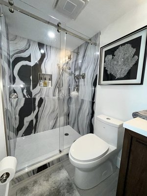 Mike’s Condo - This bathroom belongs to our dear friend Mike who allowed us to remodel his bathroom in his condo. We were able to create a brand new bathroom with all the following scopes of work. New shower tile, new toiletries, new glass shower door, paint for the walls, new toilet, new mirror, and a new vanity with a Quartz countertop.