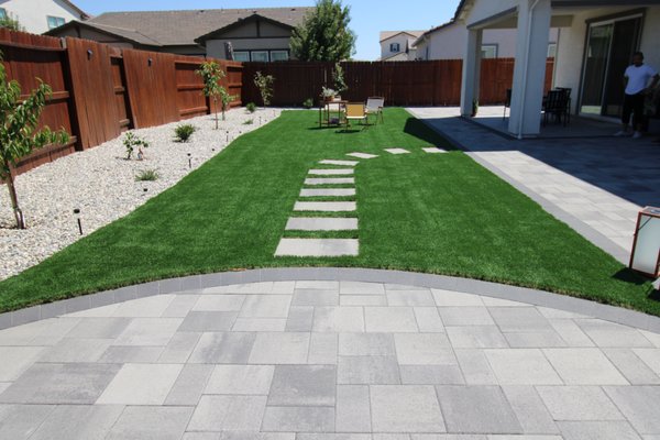 Elk Grove, CA Landscape Design & Installation - This landscape design and installation captures the sprawling, expertly laid pavers, contrasting beautifully with artificial turf. This section is a testament to the craftsmanship and dedication of our team, ensuring a smooth yet dynamic hardscape and softscape expertise. Elk Grove, CA Landscape Design & Installation - This landscape design and installation captures the sprawling, expertly laid pavers, contrasting beautifully with artificial turf. This section is a testament to the craftsmanship and dedication of our team, ensuring a smooth yet dynamic hardscape and softscape expertise.