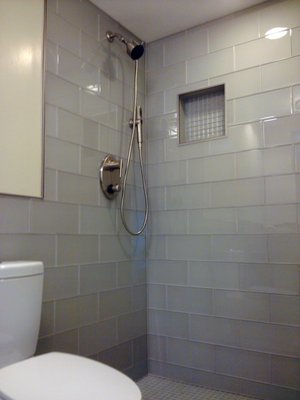 Bathroom Remodel 2015 - In just a few simple words - cool looking bathroom with blue glass tile. The size of the tile is 6 x 12 and the vendor is The Tile Shop. Overall this was a very unique design. Unfortunately I do not have better photos of the shower, but all the tile is matching inside the shower. Standing in there feels like what standing inside of a glass bottle would feel like...

Contemporary Grohe shower valve with a lifetime warranty and instead of bull-nose tile, Schlutter edge matching the brushed nickel finish of the shower set.