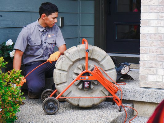Drain Cleaning - Technician preparing equipment to Hydro Jet.
