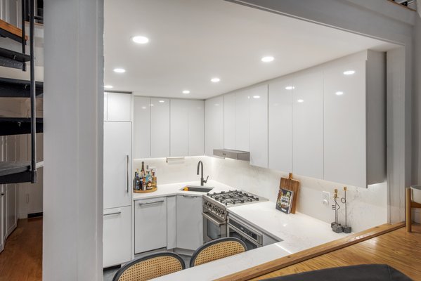 Modern White NYC Manhattan Kitchen Renovation – Custom Cabinetry & Space-Smart Design by MyHome - This Manhattan kitchen renovation by MyHome Renovation Experts transformed a compact NYC layout into a sleek, highly functional space. Featuring full-height custom cabinetry, integrated appliances, and quartz countertops, the design maximizes storage while maintaining a clean, modern aesthetic.
Recessed lighting and under-cabinet illumination enhance brightness, while the L-shaped layout improves workflow, ideal for apartment living. As a full-service NYC design-build firm, MyHome managed planning, materials, and construction in compliance with building and co-op requirements. Modern White NYC Manhattan Kitchen Renovation – Custom Cabinetry & Space-Smart Design by MyHome - This Manhattan kitchen renovation by MyHome Renovation Experts transformed a compact NYC layout into a sleek, highly functional space. Featuring full-height custom cabinetry, integrated appliances, and quartz countertops, the design maximizes storage while maintaining a clean, modern aesthetic.
Recessed lighting and under-cabinet illumination enhance brightness, while the L-shaped layout improves workflow, ideal for apartment living. As a full-service NYC design-build firm, MyHome managed planning, materials, and construction in compliance with building and co-op requirements.