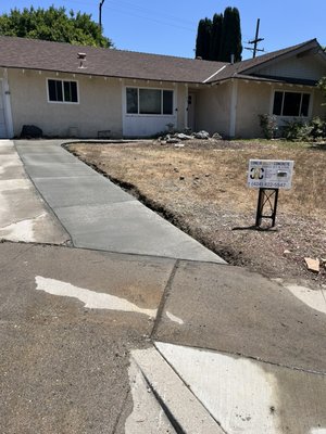 Driveway extension - Driveway extension completed to provide additional parking space for multiple vehicles. We removed the existing landscaping, prepared a solid base, and installed a durable broom-finish concrete surface designed to improve accessibility, functionality, and curb appeal.
