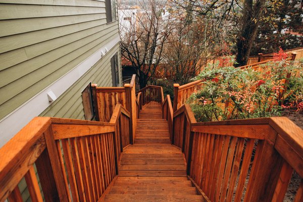Wood Staircase - This job features a fence replacement and a staircase that we built in Seattle-executed exactly how the customer imagined! For the fence we installed a cap and trim style cedar fence in place, we disposed off their old fence. We designed, planned and built out this staircase the customer had in mind, it turned out great! Everything was done out of treated wood and in the end we installed treated railings! Give us a call to (425)577-9449 for a free estimate or just submit a form here or on our website and we will get back to you asap!