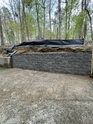 Retention wall project - Customer stated “ water washing away dirt from hillside along with the dogs running up and down”. I’m order to hold the dirt we implemented a retention wall with concrete blocks Retention wall project - Customer stated “ water washing away dirt from hillside along with the dogs running up and down”. I’m order to hold the dirt we implemented a retention wall with concrete blocks