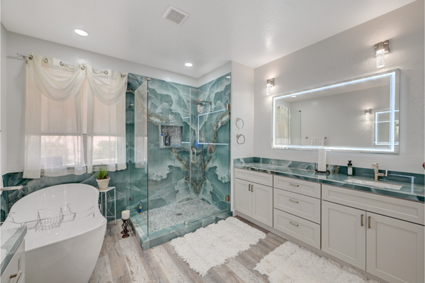 Serene Elegance: A Luxe Spa-Inspired Bathroom Remodel - We took this space from ordinary to extraordinary, introducing a serene, spa-like atmosphere. The focal point is the walk-in shower, surrounded by a mesmerizing, marble-inspired wall that adds a touch of sophistication. Complementing this is the chic free-standing bathtub, perfect for unwinding after a long day. Our attention to detail shines through in the vanity's clean lines and the elegant glass countertop, offering both beauty and functionality. The flooring, with its rich wood-look texture, infuses warmth into the modern space, crafting a balanced, inviting retreat.

Discover the craftsmanship that sets D&A Construction apart. View this project and more on our Yelp page, and envision the potential for your own home. Ready to transform your space?