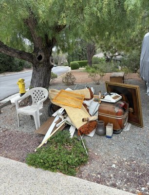 Yard Declutter - For this project, I removed a large pile of miscellaneous junk and debris that had accumulated beneath a tree near the street. The items included an old plastic chair, carpet pieces, wood scraps, a vintage television, a typewriter, framed artwork, and other assorted household clutter.

After clearing out the area, all items were removed, leaving behind a clean, open space with only the tree, fire hydrant, and surrounding landscape visible. The result is a neat and tidy curbside area free of debris and obstructions.