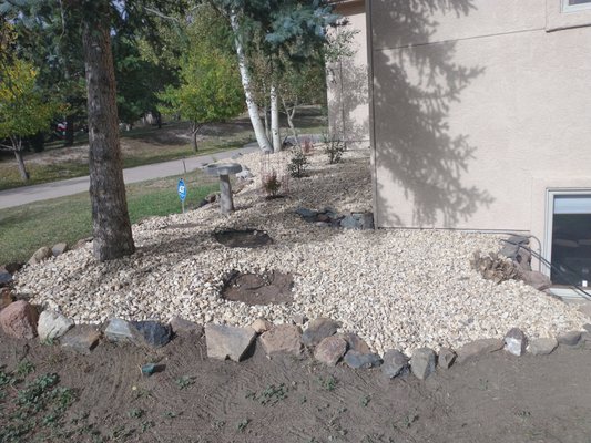 Replace Mulch with landscape rock - This home was recently purchased and landscaping was overgrown and needed a refresh.  The fire department wanted the mulch around the home replaced with rock.
