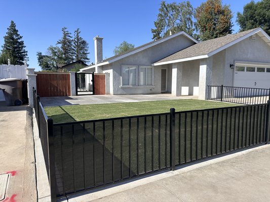Front yard remodel - This remodel was done to an existing front yard. We hauled quite a bit of dirt away and re-graded the slope. We extended the front patio also added steps with landscape lighting. For the lawn we used Celebration Bermuda. Most importantly added a security fence with privacy screens to protect the homeowners' pets.