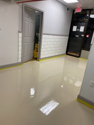 Restaurant take out area - This project is a newly remodeled restaurant. This area was the take out area adjacent to the dining area. Concrete was fully grinded, cracks and uneven areas were patched and filled. 1 coat of epoxy primer/sealer was applied then top coated with a solid color epoxy. 2 coats of polyaspartic clear coat were applied for added durability. Restaurant take out area - This project is a newly remodeled restaurant. This area was the take out area adjacent to the dining area. Concrete was fully grinded, cracks and uneven areas were patched and filled. 1 coat of epoxy primer/sealer was applied then top coated with a solid color epoxy. 2 coats of polyaspartic clear coat were applied for added durability.