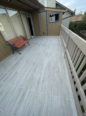 deck resurfacing with tile - We removed old caparpet fixed all the wrot put down a waterproof membrane 
then installed tile for a deck that will last and last!