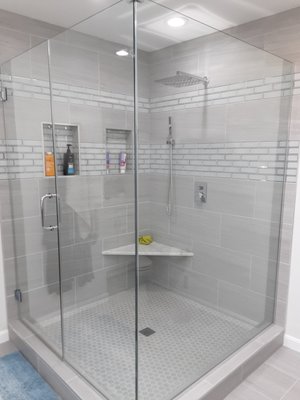 Bathroom remodeling - Arlington, VA - One of our latest bathroom remodeling jobs in Arlington, VA. We build a beautiful corner shower with a seat. The gray 12x24 tile was complimented with subway tile to create a modern and stylish look. The customer was extremely happy with the result and we are looking forward to work with them again in the future. If you are looking for a remodeling contractor, contact us and take advantage of our free in-house consultation!