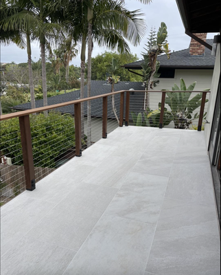 Encinitas Balcony Remodel - New waterproofing, large format tiles and Ipe Wood railing with stainless steel cables. Encinitas Balcony Remodel - New waterproofing, large format tiles and Ipe Wood railing with stainless steel cables.