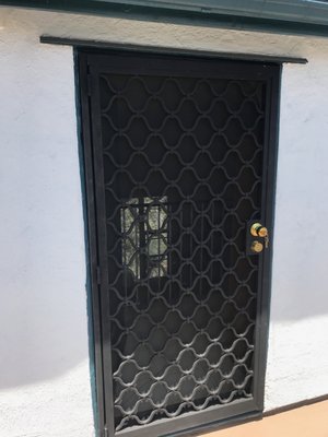 Custom Security Door & Window Guard – Santa Monica - We crafted and installed a custom wrought iron security door and matching window guard, designed with decorative geometric patterns that provide both safety and curb appeal. Built for strength and style, these pieces enhance home security while complementing the property’s exterior.