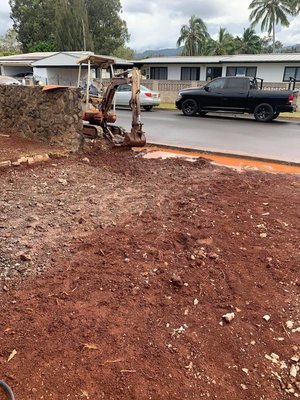 Rock Wall, front yard and backyard - We made 2 beautiful walls for a client in Wahiawa. We also made them a new driveway and concrete slabs on the side of their house.