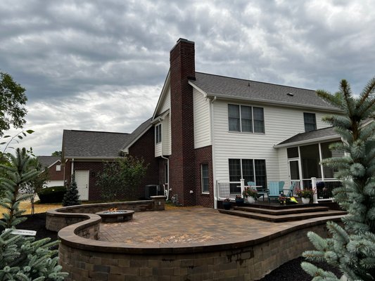 Paver Patio with Curved Sitting Wall - This was one of our favorites! This project included a paver patio with a gas firepit, curved sitting wall, dedicated seating area, custom steps to raised deck, and added electrical outlets to constructed pillars. Paver Patio with Curved Sitting Wall - This was one of our favorites! This project included a paver patio with a gas firepit, curved sitting wall, dedicated seating area, custom steps to raised deck, and added electrical outlets to constructed pillars.