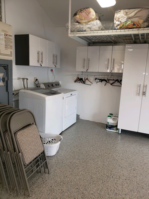 Orange County Cabinet Installation - For this remodel, we helped the customer with current items by storing them prior to the installation and unloading after the installation was complete. The laundry now has it's own designated area, sectioned off with cabinets, clothes hanging rod, and a strategically placed overhead rack. A slatwall was installed for easy access near the garage door.