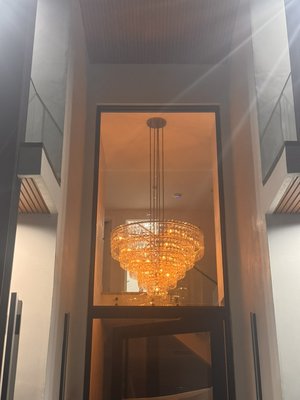 Luxury chandelier installation - This project features several chandelier installations in a modern residential home. Our team at N&S Electrical Services handled everything from electrical wiring and ceiling support to final fixture mounting. Each chandelier was carefully leveled and safely connected to ensure long-lasting performance and a clean, elegant finish. From luxury entryway lights to custom dining room fixtures, every detail was completed to code and with precision craftsmanship.