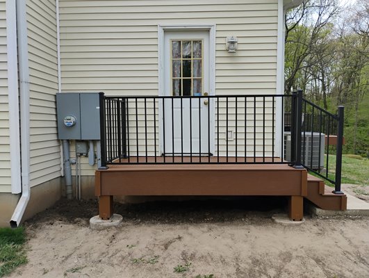 Double Composite Deck - The old decks have lived their life, but the new age is now. Composite decking, stainless steel screws, large concrete footings, and powder coated steel railings. Built to last all around.