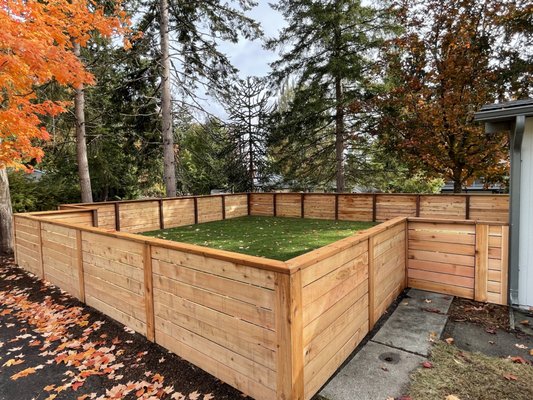 Kenmore - $30,000 - This space needed a lot of prep work before we could begin installation. We removed all overgrown foliage and cleared the space to create the ideal surface to install the fence. Once the area was clear and even, we moved forward with the project. High quality wood provides an extra layer of privacy. The fence will withstand all types of weather, retaining its original appearance with minimal maintenance over time. Lush, green sod created an instant lawn. We rolled and fit the sod to create a seamless appearance that will continue to thrive over time. Kenmore - $30,000 - This space needed a lot of prep work before we could begin installation. We removed all overgrown foliage and cleared the space to create the ideal surface to install the fence. Once the area was clear and even, we moved forward with the project. High quality wood provides an extra layer of privacy. The fence will withstand all types of weather, retaining its original appearance with minimal maintenance over time. Lush, green sod created an instant lawn. We rolled and fit the sod to create a seamless appearance that will continue to thrive over time.