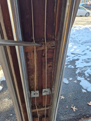 Termite Inspections and treatments - Damage to an exposed beam in a garage from termite activity. Termite inspections and treatments.