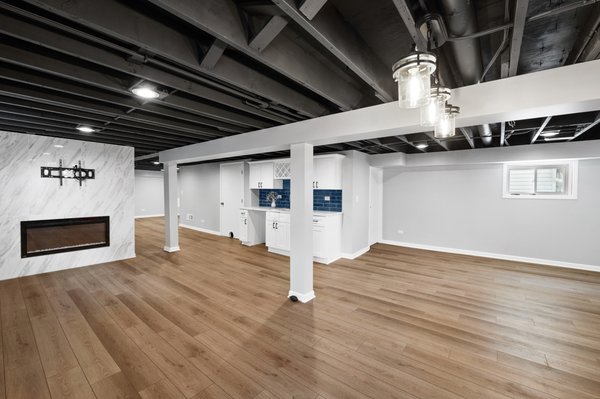 Basement Remodel With Spray Paint Ceiling - Basement finishing with wet bar, new bathroom, fire place and windows. Basement Remodel With Spray Paint Ceiling - Basement finishing with wet bar, new bathroom, fire place and windows.