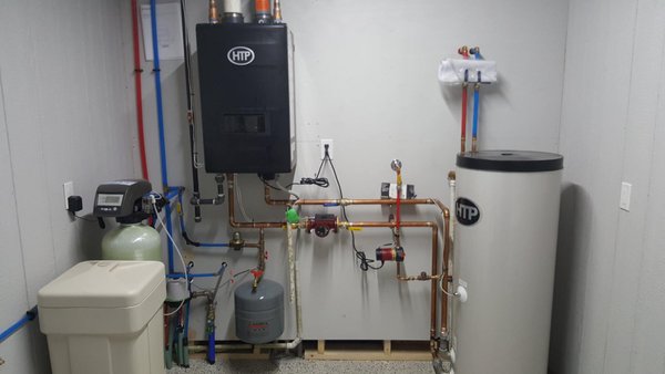 Mechanical Room - Plumbing a mechanical room that includes a tankless HTP water heater with HTP storage tank, water softener and expansion tank. Mechanical Room - Plumbing a mechanical room that includes a tankless HTP water heater with HTP storage tank, water softener and expansion tank.