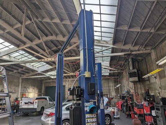 Service Garage - Install for customer in Oakland for a Service Garage where multiple LED lights were installed, flood lights on wall wire reroute into conduit to vehicle lift motor.