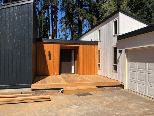 Lake Oswego exterior face lift 2020 - Home needed some siding repairs, then paint to freshen up the exterior. They added the cedar vertical clear stained siding at the entryway. Then added the epi deck on the front for a place to sit and watch the sun set. New garage doors to finish off the beauty of this home.