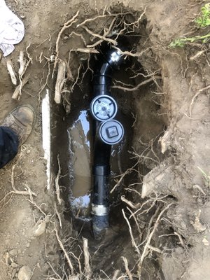Clean out and back water valve installaion - This sewer line failed due to an old and un-maintained backwater valve. This caused sewage to back up inside the home. We located the buried clean out and backwater valve. We installed an all new ABS clean out and back water valve, and raised the access vault to ground level. The rocks were placed per the owner request to ensure no plant growth from covering the access vault Clean out and back water valve installaion - This sewer line failed due to an old and un-maintained backwater valve. This caused sewage to back up inside the home. We located the buried clean out and backwater valve. We installed an all new ABS clean out and back water valve, and raised the access vault to ground level. The rocks were placed per the owner request to ensure no plant growth from covering the access vault